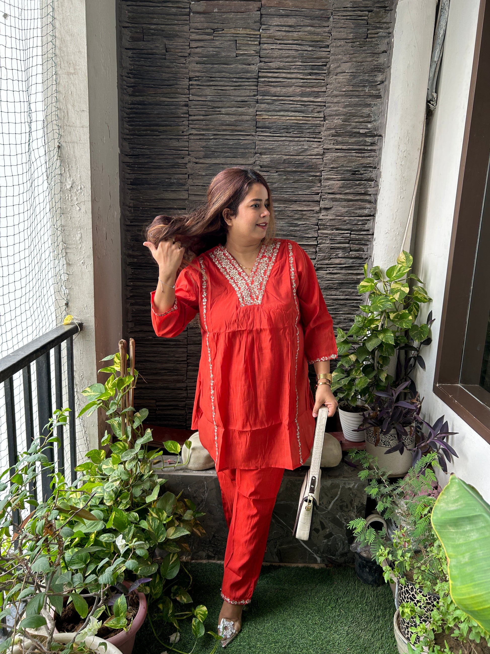Woman wearing a dark orange Mal Chanderi Co-Ord set with silver color embroidery.